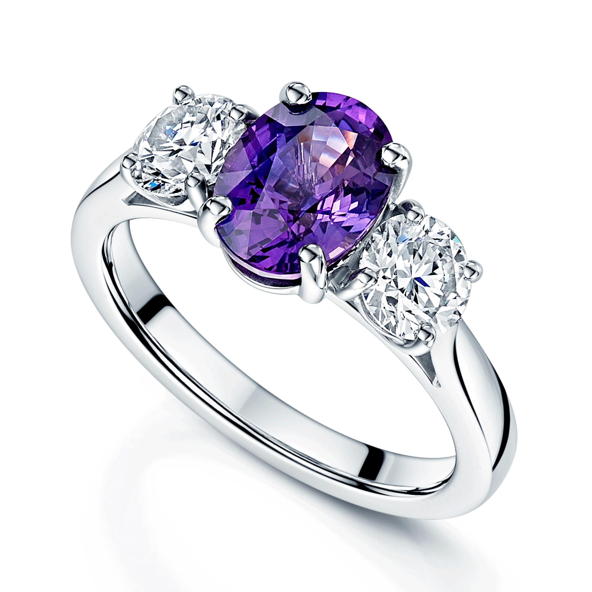 Platinum Oval Cut Purple Sapphire And Round Brilliant Cut Diamond Three Stone Ring