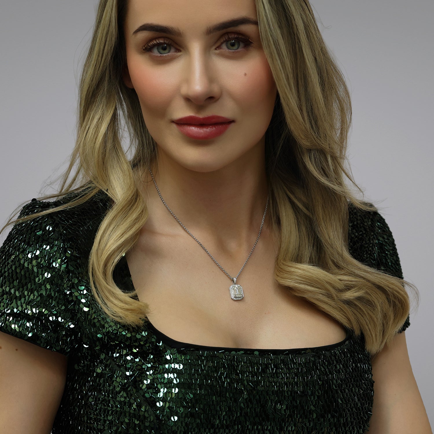 18ct White Gold GIA Certificated Emerald Cut Diamond Pendant With a Grain Set Diamond Halo Frame And A Diamond Bale