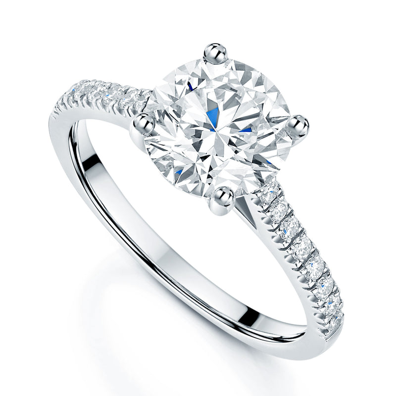 Platinum Round Brilliant Cut Diamond Solitaire Ring With Diamond Shoulders