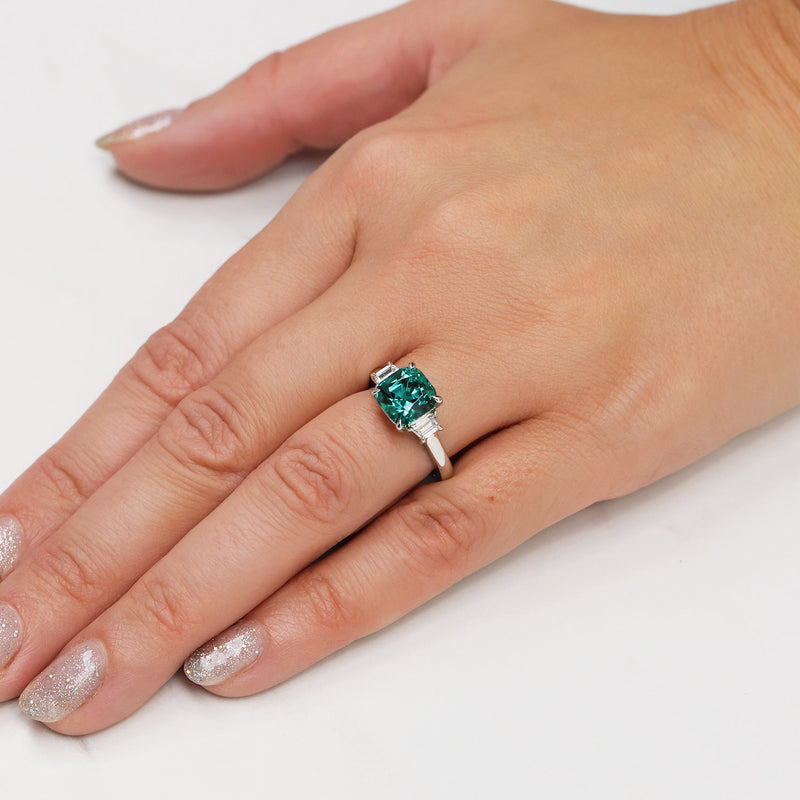 Berry's Platinum Cushion Cut Indicolite Tourmaline And Trapeze Cut Diamond Three Stone Ring - Berry's Jewellers