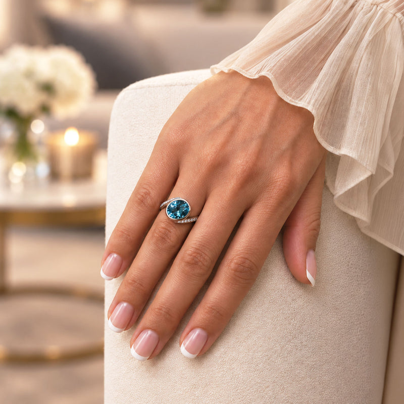 Platinum Oval Blue Zircon and Diamond Twist Ring
