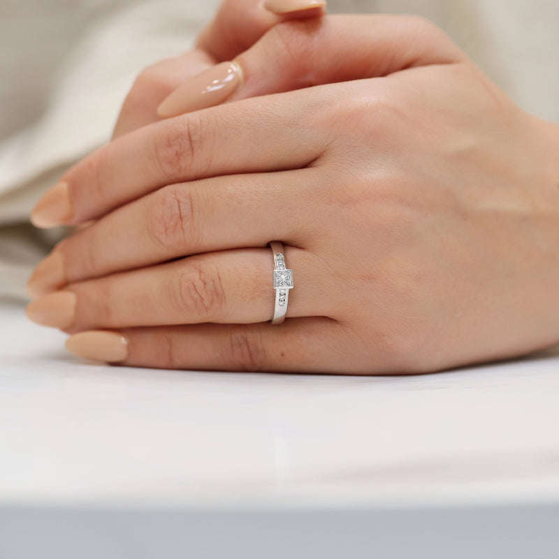 Berry's 18ct White Gold Princess Cut Diamond Rub Over Set Solitaire Ring With Round Brilliant Cut Channel Set Diamond Shoulders - Berry's Jewellers