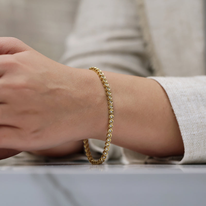 Berry's 18ct Yellow Gold Round Brilliant Cut Diamond Tennis Bracelet In A Rub Over Setting - Berry's Jewellers