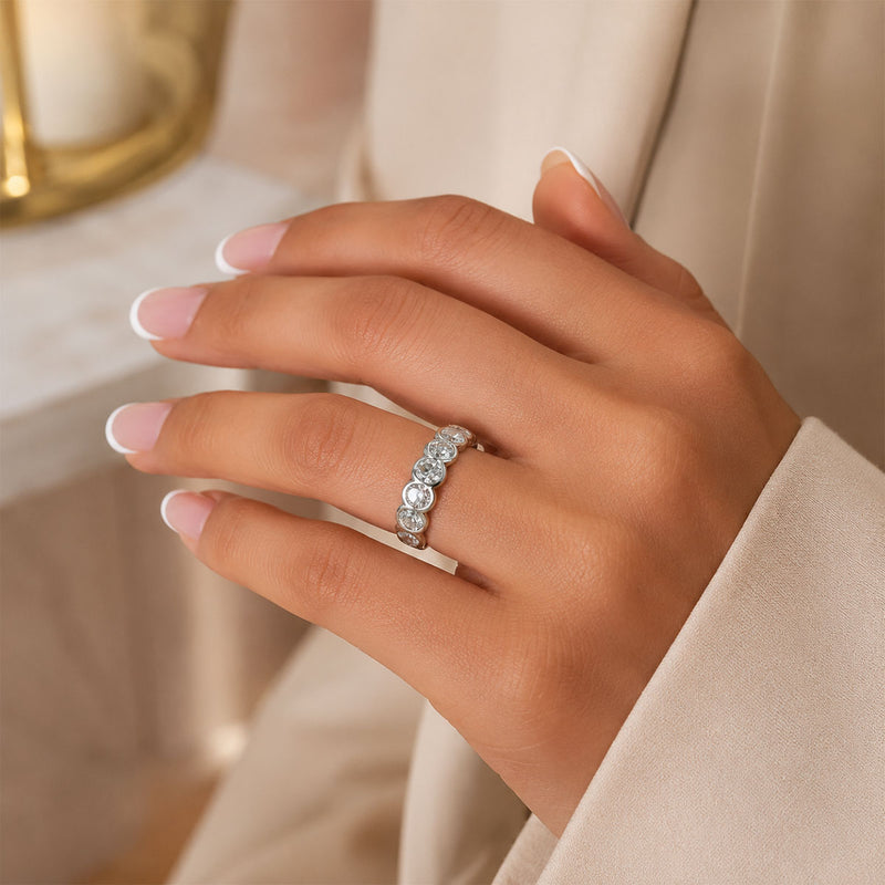 Platinum Oval Cut Diamond Seven Stone Rub Over Set Eternity Ring