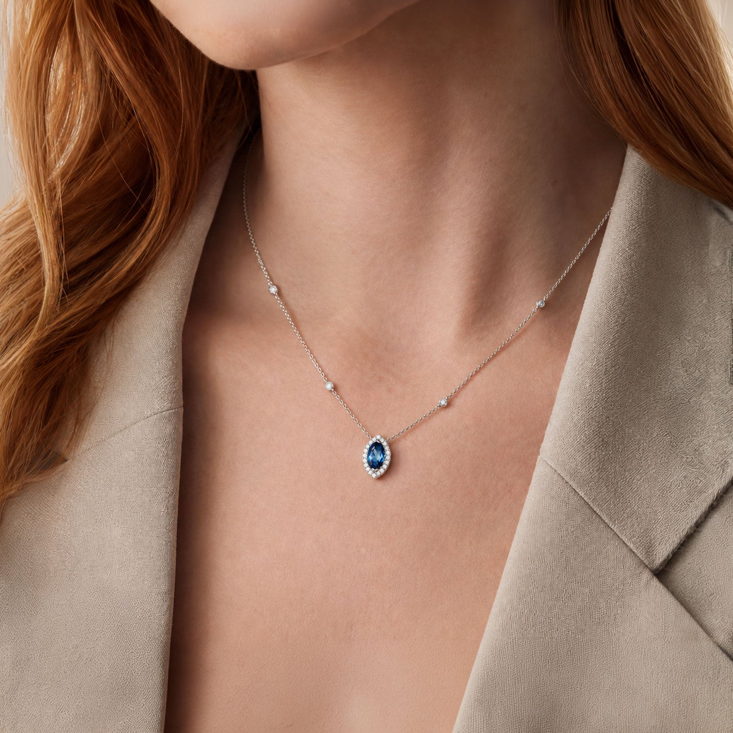 18ct White Gold Marquise London Blue Topaz And Diamond Halo Pendant With Diamonds On The Chain