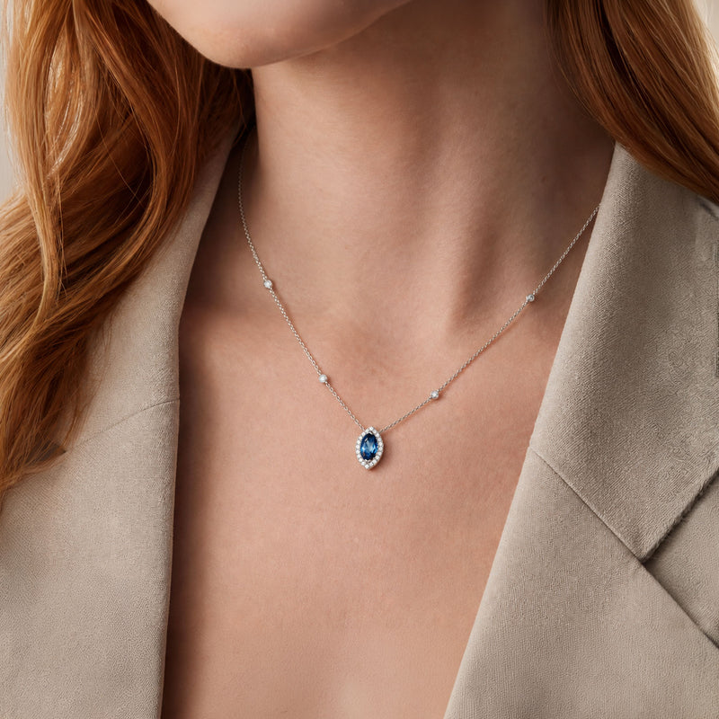 18ct White Gold Marquise London Blue Topaz And Diamond Halo Pendant With Diamonds On The Chain