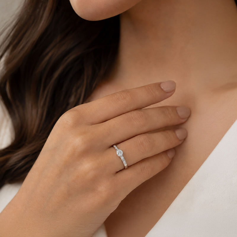 Platinum Round Brilliant Cut Diamond Single Stone Ring With Baguette Cut Diamond Channel Set Shoulders