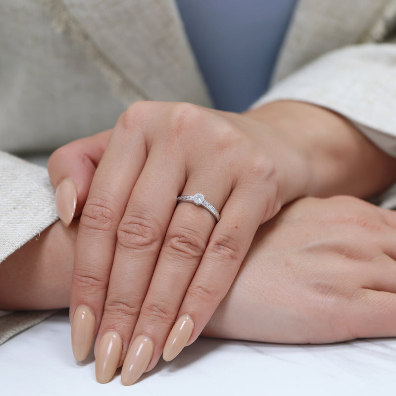 Berry's Platinum Round Brilliant Cut Diamond Single Stone Ring With Baguette Cut Diamond Channel Set Shoulders - Berry's Jewellers