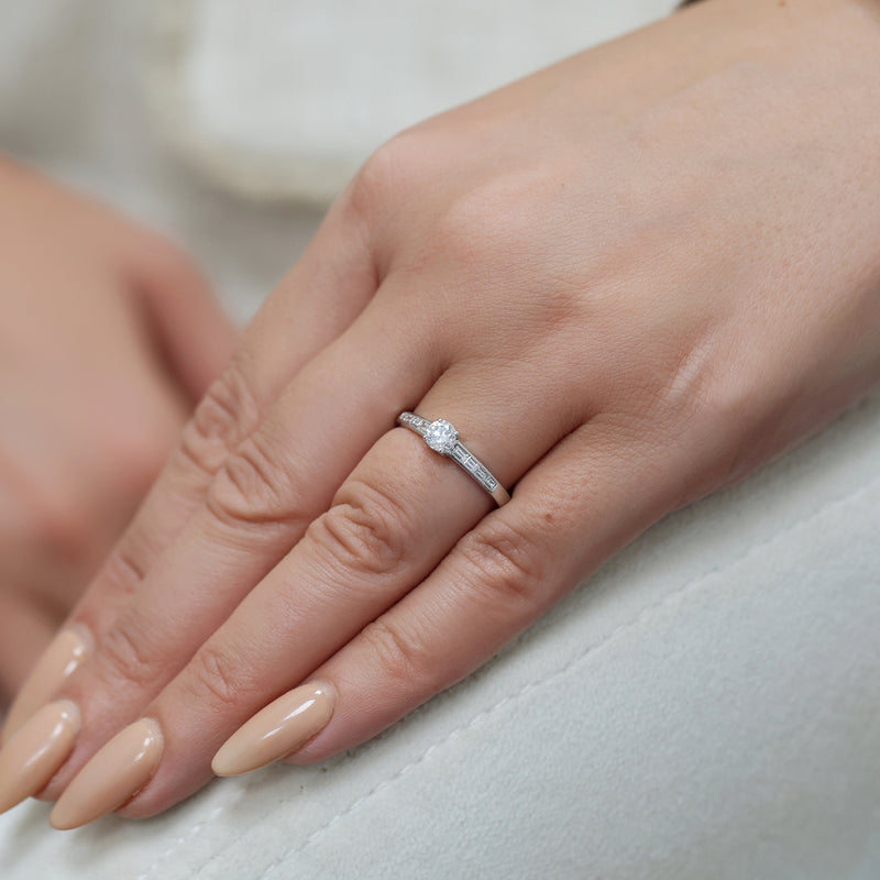 Berry's Platinum Round Brilliant Cut Diamond Single Stone Ring With Baguette Cut Diamond Channel Set Shoulders - Berry's Jewellers