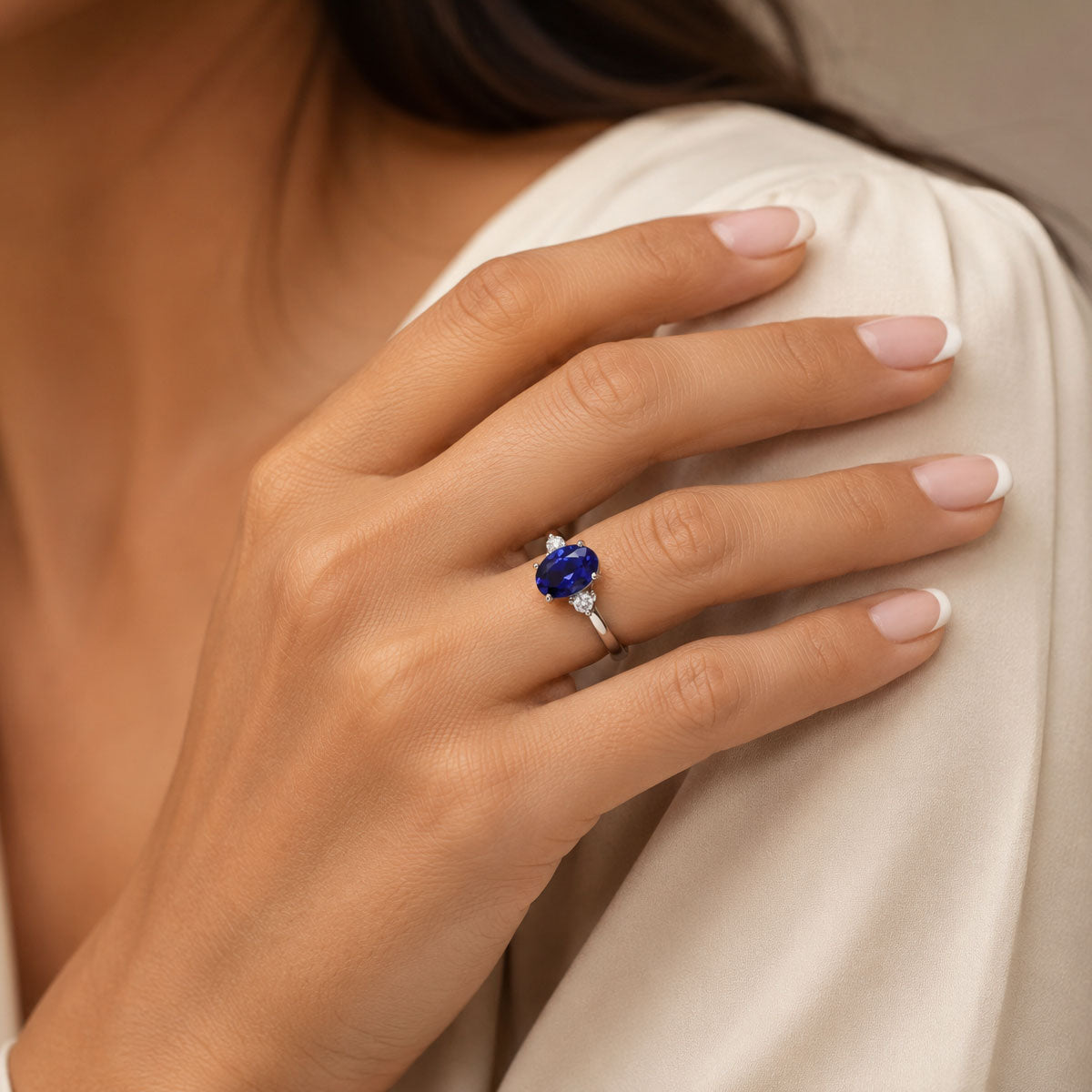 Platinum Oval Cut Tanzanite And Round Brilliant Three Stone Ring
