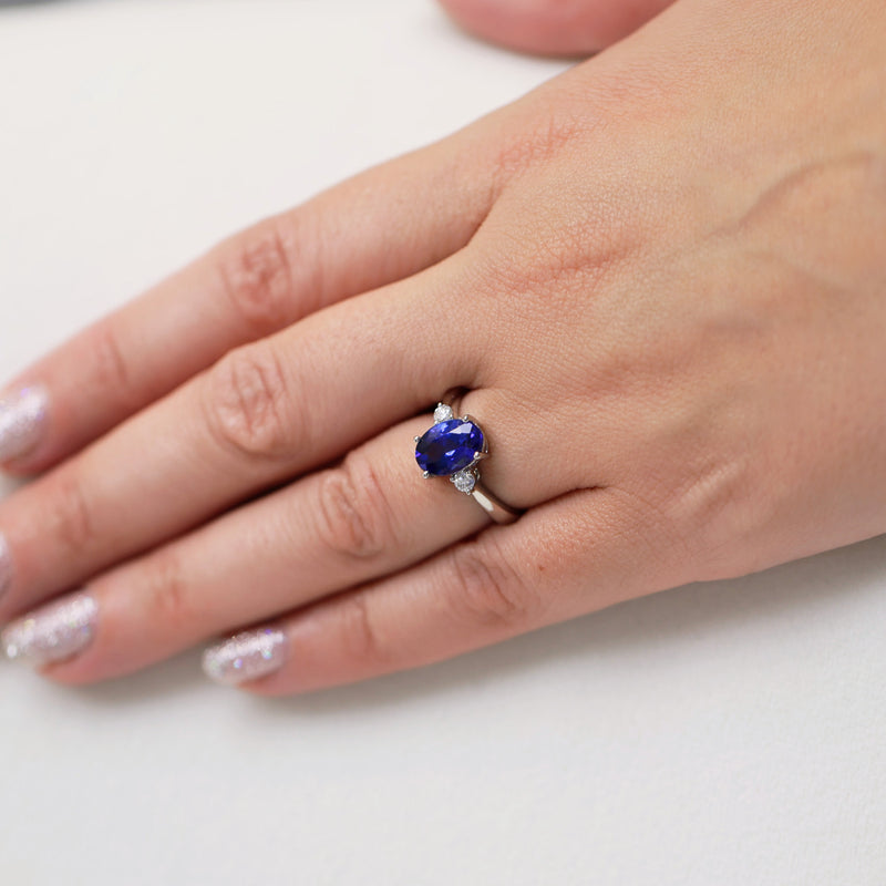 Platinum Oval Cut Tanzanite And Round Brilliant Three Stone Ring