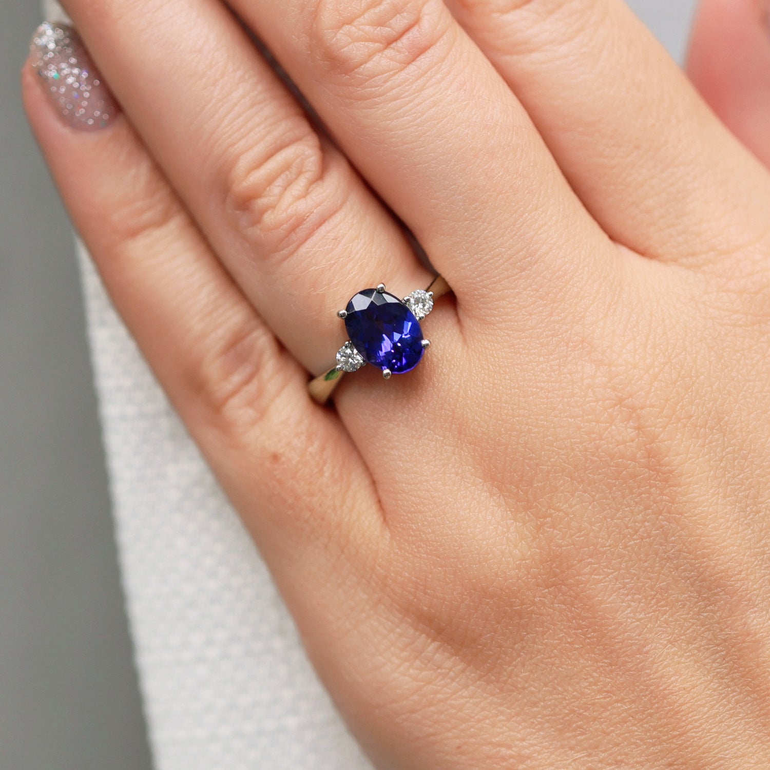Platinum Oval Cut Tanzanite And Round Brilliant Three Stone Ring