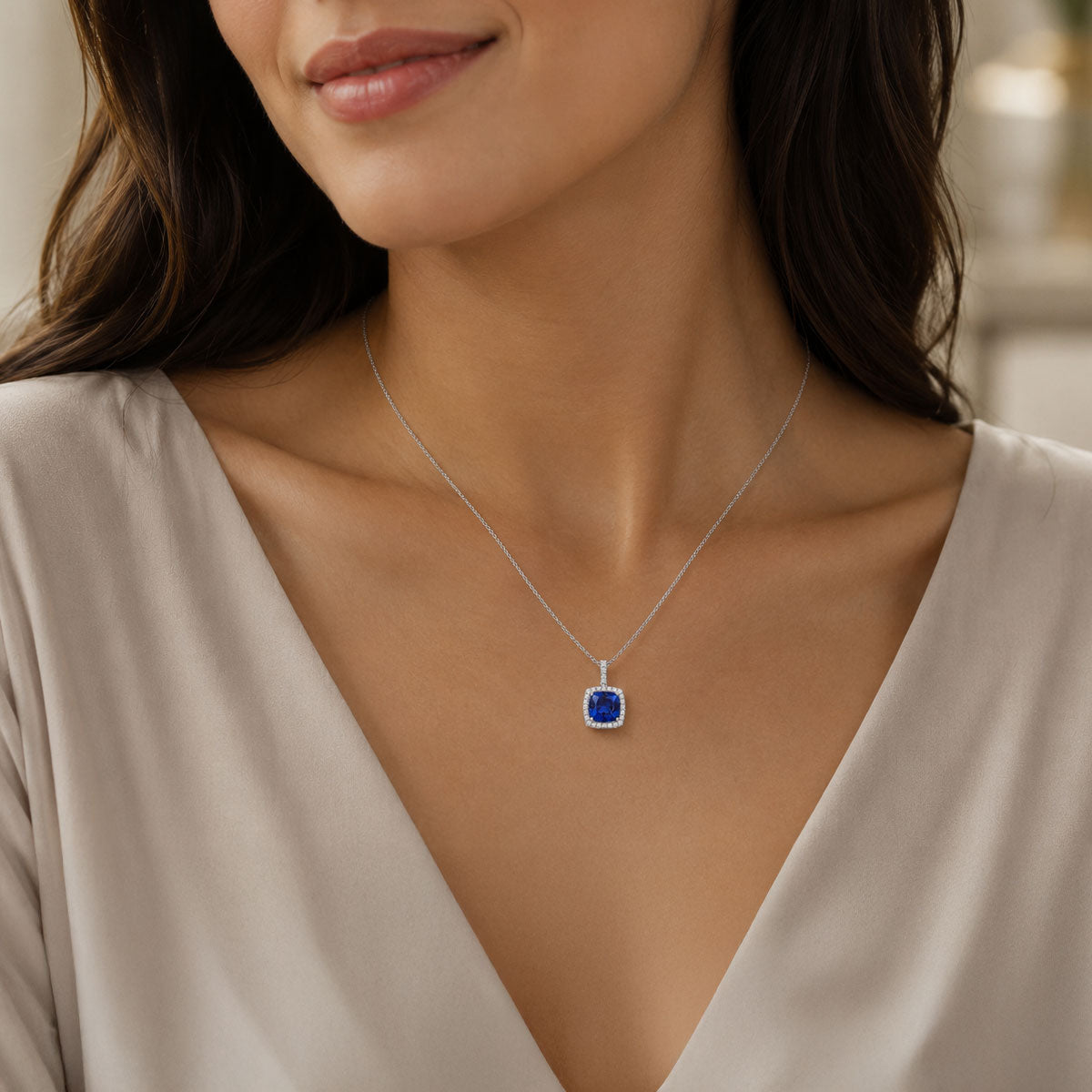 18ct White Gold Cushion Cut Tanzanite And Diamond Halo Pendant With A Diamond Bale