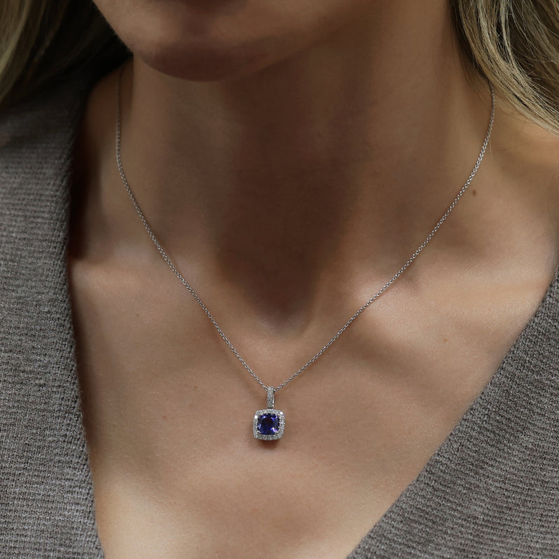 18ct White Gold Cushion Cut Tanzanite And Diamond Halo Pendant With A Diamond Bale