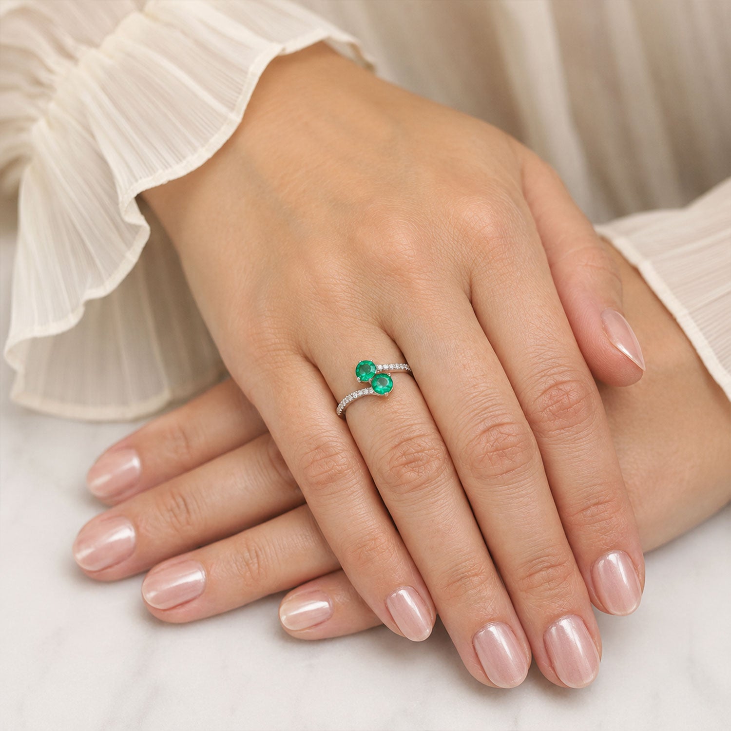 Berry's Platinum Round Brilliant Cut Emerald Two Stone Twist Ring With Diamond Set Shoulders - Berry's Jewellers