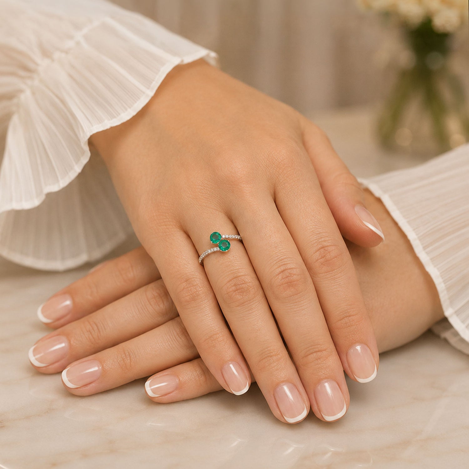 Platinum Round Brilliant Cut Emerald Two Stone Twist Ring With Diamond Set Shoulders