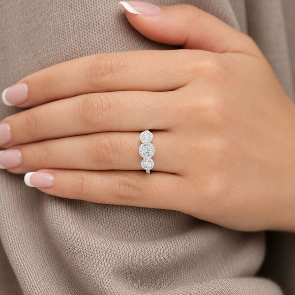 Platinum Round Brilliant Diamond Fancy Three Stone Ring With A Diamond Halo Surround