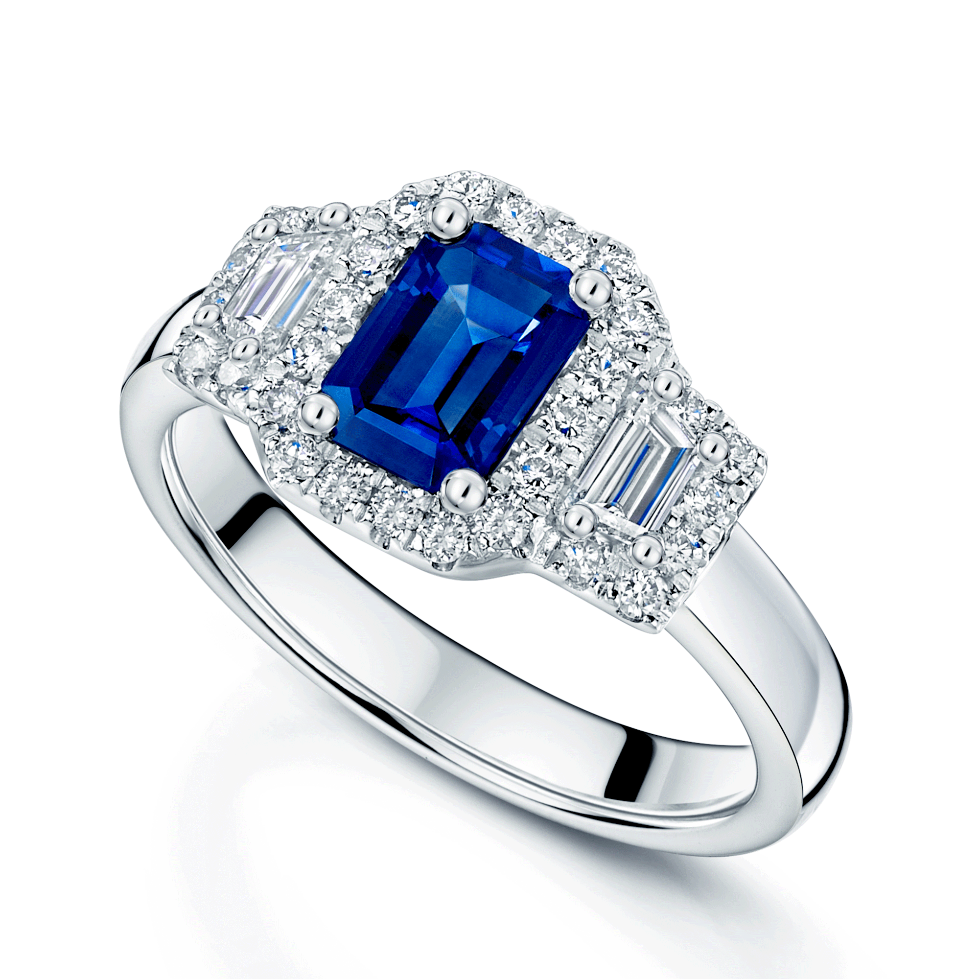 Platinum Sapphire And Baguette Cut Diamond Three Stone Ring With A Halo Surround