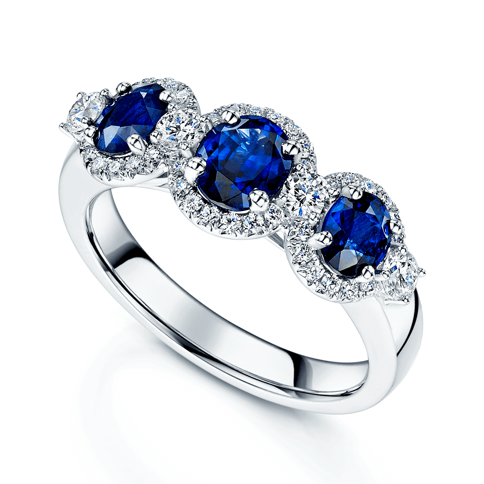 Platinum Round Brilliant Sapphire Fancy Three Stone Ring With A Diamond Halo Surround