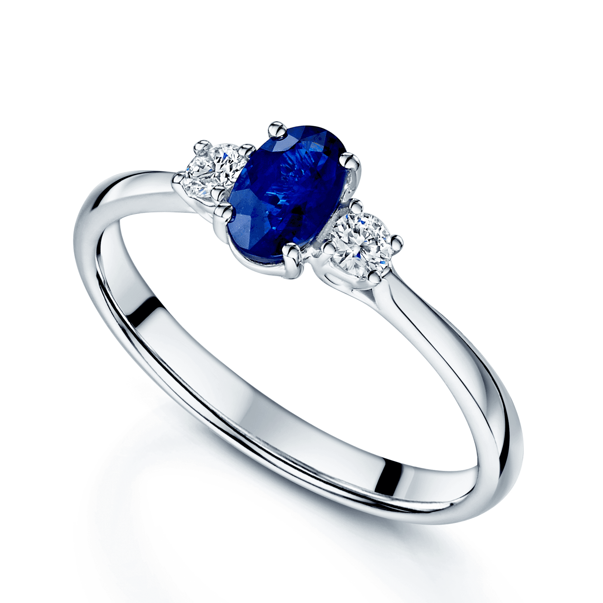 Platinum Oval Sapphire And Round Brilliant Diamond Three Stone Ring