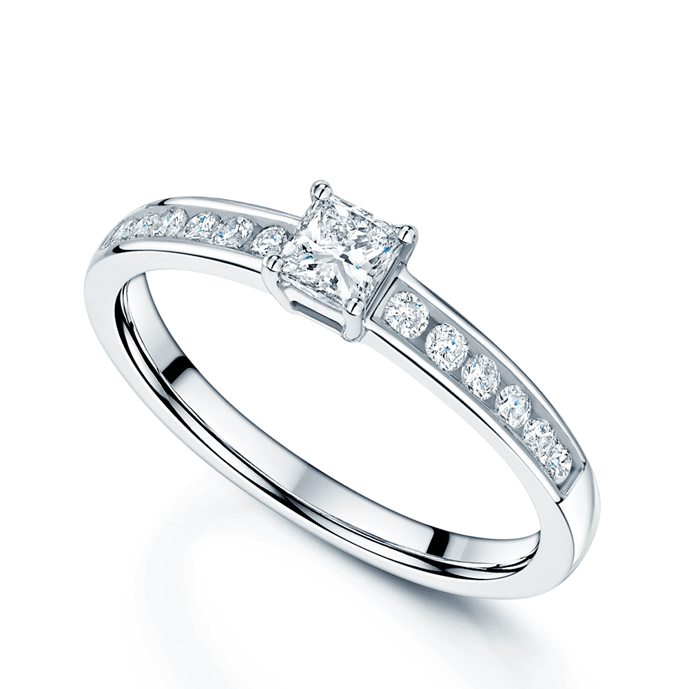 Platinum Princess Cut Diamond Single Stone Claw Set Ring With Round Brilliant Cut Channel Set Shoulders