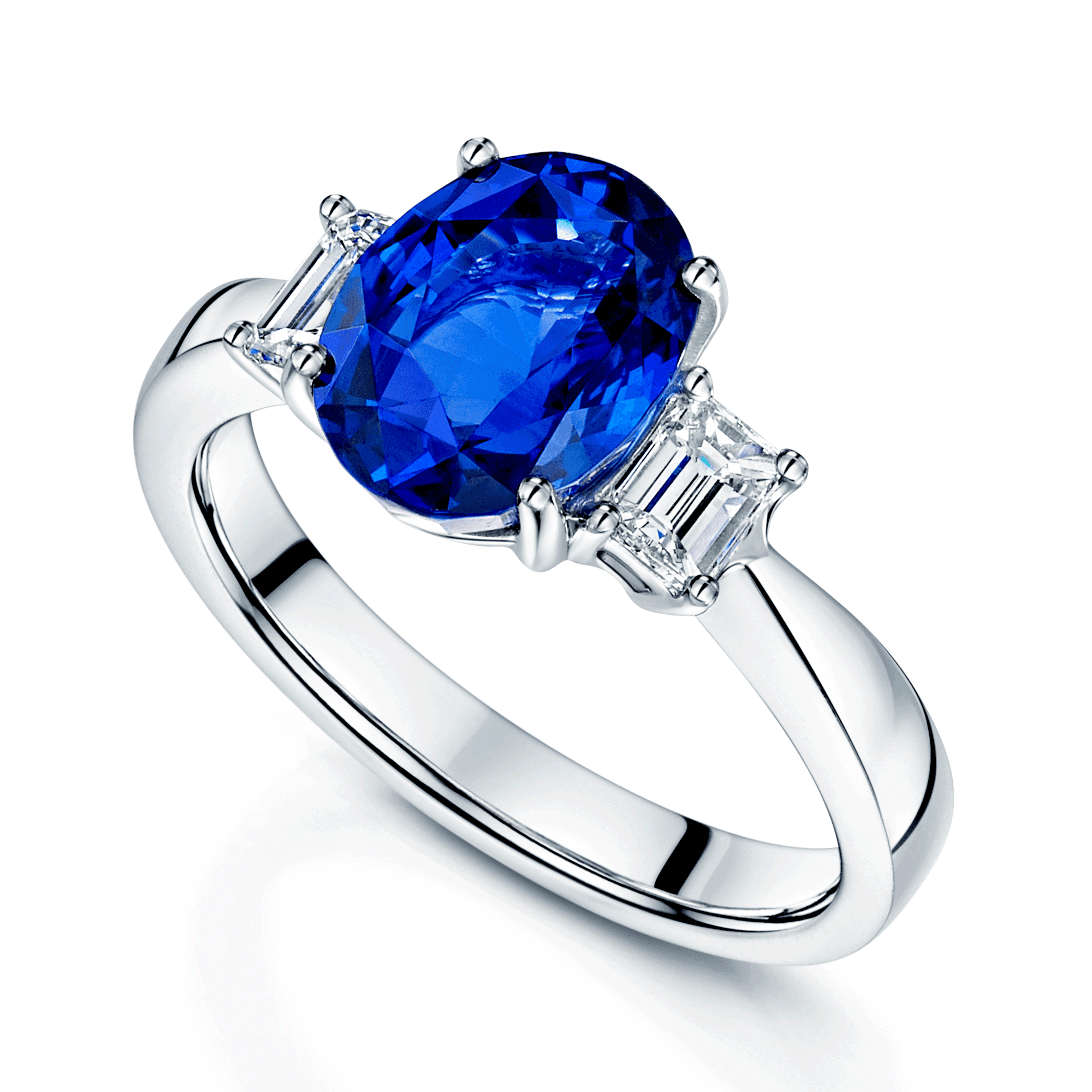 Platinum Three Stone Oval Sapphire And Emerald Cut Diamond Claw Set Ring